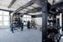 Modern gym facility featuring state-of-the-art training zone, weights, and cardio equipment in a bright, spacious environment.
