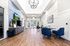 Modern lobby with high ceilings and elegant decor, featuring comfortable seating and natural light.