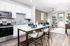 Elegant open-concept kitchen and living area with modern appliances, stylish dining setup, and inviting natural light, perfect for entertaining.