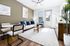Inviting living room with modern decor, plush seating, and abundant natural light, perfect for relaxation and entertaining.