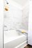 Luxurious bathroom featuring elegant marble tile, a sleek modern bathtub, and spa-like amenities.