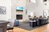 Luxurious and modern living room with elegant marble fireplace, chic leather sofa, and contemporary lighting fixtures.