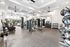 Modern gym with state-of-the-art fitness equipment, large windows, and sleek contemporary design.