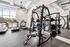 Modern fitness center with state-of-the-art exercise equipment, large windows offering scenic views of a sparkling pool, creating a refreshing workout atmosphere.