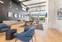 Elegant and modern lounge area with high ceilings, stylish furniture, and expansive windows offering a bright and inviting atmosphere.