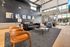 Luxurious contemporary living room with high ceilings, elegant seating, and large windows overlooking a scenic view.