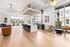 Spacious and modern open-concept living area with elegant hardwood floors, a sleek kitchen island, and floor-to-ceiling windows offering stunning views.