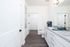 Bright and modern bathroom with granite countertop, sleek cabinetry, and elegant fixtures, perfect for a refreshing retreat.
