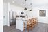 Sleek modern kitchen with granite countertops, stainless steel appliances, and elegant pendant lighting, perfect for entertaining.