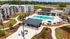 Charming apartment complex with a sparkling pool, modern clubhouse, and beautifully landscaped pathways, offering an inviting and luxurious living experience.