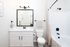 Bright and modern bathroom featuring sleek vanity with black accents, elegant lighting, and a pristine bathtub with stylish fixtures.