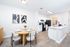 Modern open-concept kitchen and dining area with sleek cabinetry and elegant decor, ideal for stylish entertaining.