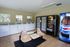 Modern laundry facility equipped with washing machines, convenient vending machine, and comfortable seating area.