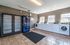 Bright laundry room with modern washing machines, ample natural light, and convenient vending machine in a welcoming apartment complex.