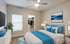 Chic bedroom featuring a comfortable bed with vibrant blue accents, modern decor, and a spacious closet in a bright, inviting space.