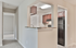 Inviting apartment interior showcasing a modern kitchen with granite countertops, open layout with cozy carpeted living area, and rich wooden cabinetry.