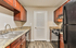 Charming kitchen with rich wooden cabinets, sleek granite countertops, and modern appliances. Ideal for culinary enthusiasts.