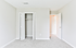 Bright bedroom with fresh carpeting and a spacious closet, ideal for modern living.