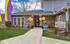 Charming apartment welcome center with colorful balloons and inviting garden pathway.