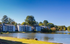 Charming lakeside apartments surrounded by lush greenery, offering serene views and tranquil living.