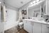 Contemporary bathroom with elegant fixtures, a spacious vanity, and a relaxing bathtub adorned with modern decor.