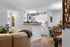 Welcoming apartment with cozy seating area, bright kitchen, and elegant dining space accented by charming decor.