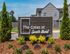Inviting entrance to The Gates at South Bend with lush landscaping and modern architectural design.