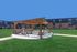 Charming apartment complex featuring a spacious outdoor patio with a wooden pergola, perfect for relaxation and social gatherings.