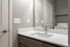 Modern bathroom featuring sleek fixtures and a washer-dryer unit for convenient apartment living.