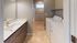 Contemporary laundry room with sleek bathroom and energy-efficient washer and dryer.