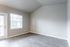 Bright and airy room featuring modern hardwood flooring, large windows, and high ceilings, perfect for a stylish living space.