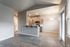 Bright modern apartment with open-concept kitchen and elegant wood flooring offering a sophisticated living space.