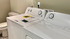 Modern laundry room featuring a sleek washer and dryer set, complemented by elegant patterned flooring.
