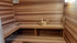 Luxurious wooden sauna room featuring natural wood paneling and comfortable seating, perfect for relaxation.