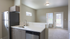 Modern apartment interior featuring a sleek kitchen with stainless steel appliances, stylish cabinetry, and bright open living space.