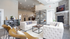 Inviting modern living area with plush sofas, elegant decor, and a cozy stone fireplace, perfect for relaxation and social gatherings.