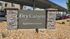 Inviting entrance sign for Dry Canyon Apartment Homes surrounded by stylish stone pillars and desert landscaping.