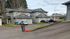 Charming suburban apartment buildings with garages and parking, surrounded by lush trees and peaceful neighborhood setting.