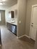 Modern kitchen with sleek cabinetry, stainless steel appliances, and elegant wood flooring.