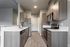 Sleek modern kitchen featuring stainless steel appliances, elegant cabinetry, and pristine countertops.