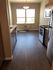 Bright and inviting kitchen with modern appliances, elegant cabinetry, and large windows providing abundant natural light on gleaming wooden floors.