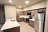 Modern kitchen with sleek stainless steel appliances, elegant cabinetry, and a spacious island with a stylish countertop.