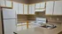 Spacious kitchen with modern appliances, sleek countertops, and ample cabinetry in a cozy apartment.