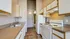 Charming kitchen with modern white appliances, ample cabinetry, and sleek countertops, perfect for culinary adventures.
