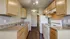 Modern kitchen with sleek wooden cabinets, spacious countertops, and bright lighting, perfect for culinary enthusiasts.