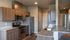 Modern kitchen with sleek wooden cabinetry, granite countertops, stainless steel appliances, and a stylish breakfast bar.
