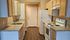 Bright and inviting kitchen with ample cabinetry, modern appliances, and stylish countertops offering functionality and elegance.