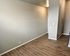 Modern apartment interior showcasing elegant hardwood floors and freshly painted walls, perfect for a stylish living space.