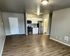 Contemporary open-concept apartment with sleek hardwood floors, modern kitchen with stainless steel appliances, and ample natural light.