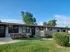 Charming apartment complex with manicured lawns and inviting leasing office, offering a welcoming community environment.